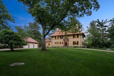 Exterior of Mediterranean Colonial home at 45 The Ledges Road, Newton, MA with tile roof and stucco facade