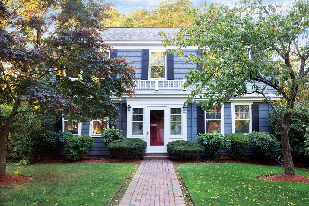 Exterior of 5-bedroom colonial at 93 Beaumont Avenue Newton with blue siding and trees